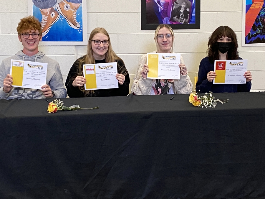 four students signing to college for visual art